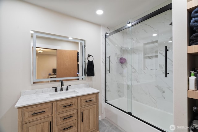 full bath with vanity and bath / shower combo with glass door