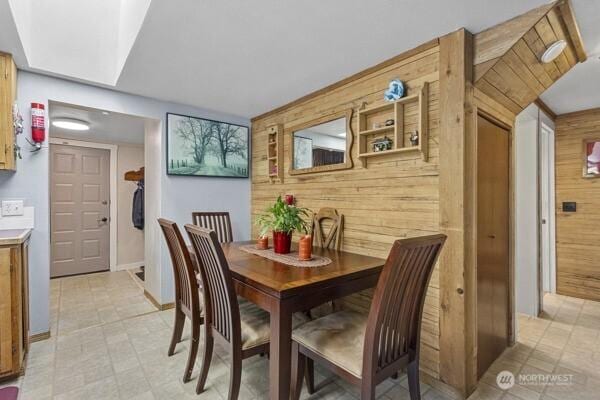 dining area featuring wooden walls