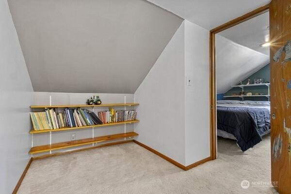 bonus room featuring carpet floors, vaulted ceiling, and baseboards