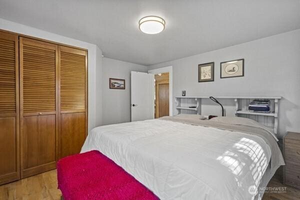 bedroom with a closet and wood finished floors