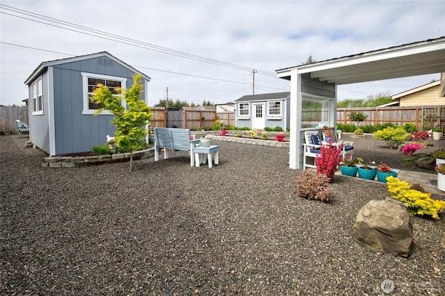 fenced backyard featuring a shed and an outdoor structure