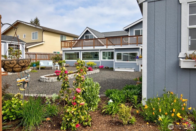 rear view of property with a balcony, fence, and a patio area