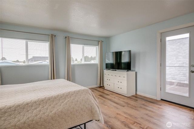 bedroom with light wood-type flooring and baseboards