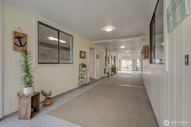 hall featuring wood walls
