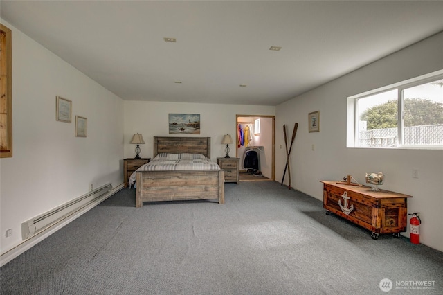 bedroom with a baseboard heating unit and carpet floors