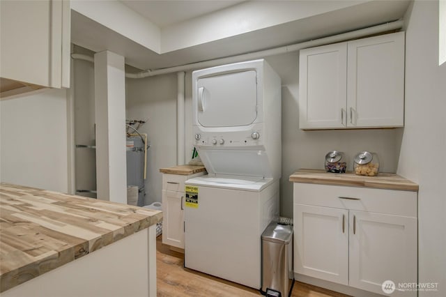 clothes washing area featuring stacked washer / drying machine and light wood-type flooring