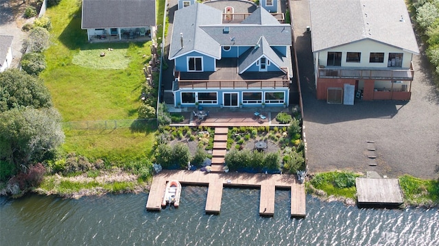 aerial view of property and surrounding area featuring a large body of water