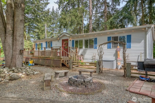 view of front of house featuring a fire pit and a deck