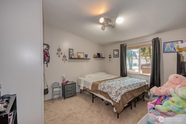 bedroom with light carpet and lofted ceiling
