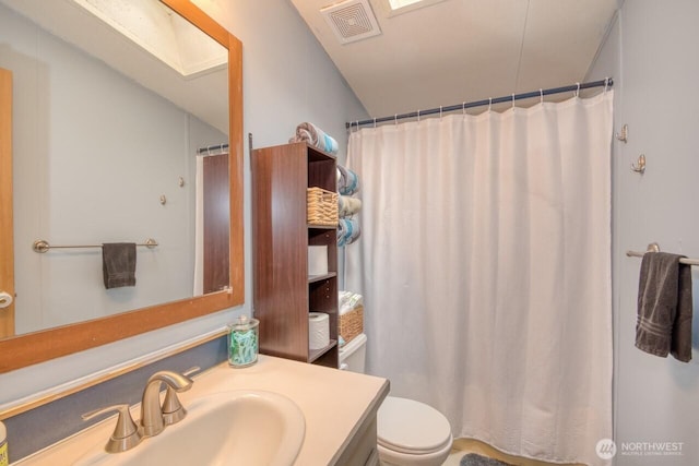 bathroom featuring vanity, toilet, and a shower with shower curtain