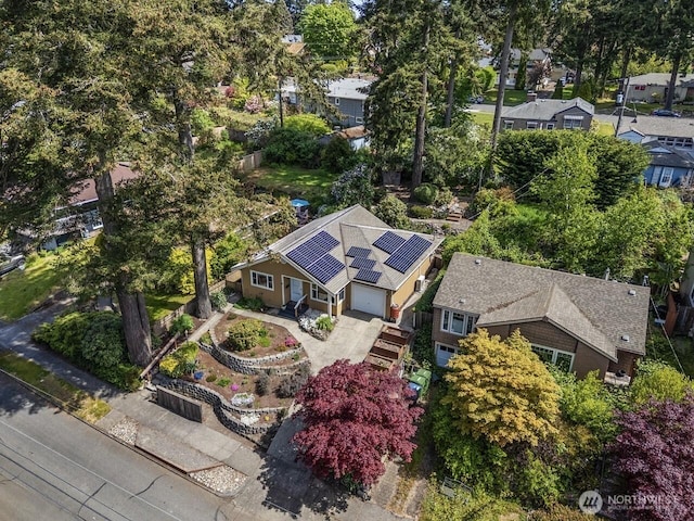 aerial perspective of suburban area featuring a tree filled landscape