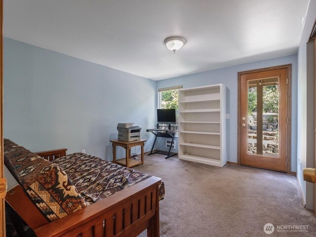 carpeted bedroom with access to outside