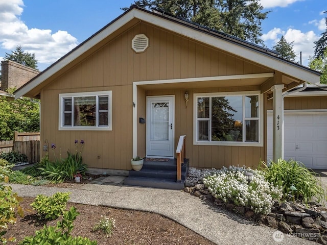 view of front facade with a garage and fence