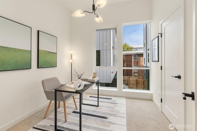 home office featuring carpet floors, a chandelier, and baseboards