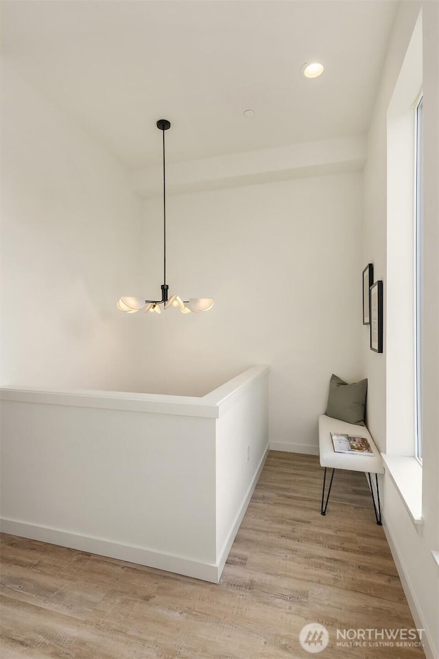 hall with light wood finished floors, recessed lighting, and baseboards