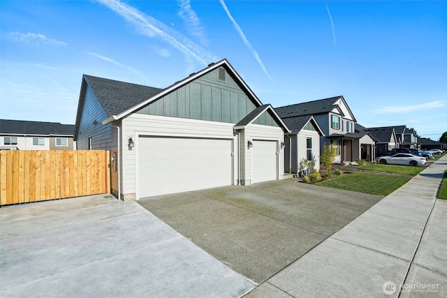 18009 NE 46th Ct, Vancouver, WA 98686 - view of front facade featuring board and batten siding, concrete driveway, an attached garage, and a residential view