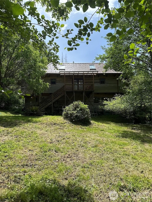 5790 NE Old Mill Rd NE, Bainbridge Island, WA 98110 - back of property featuring stairway, a yard, a deck, and metal roof