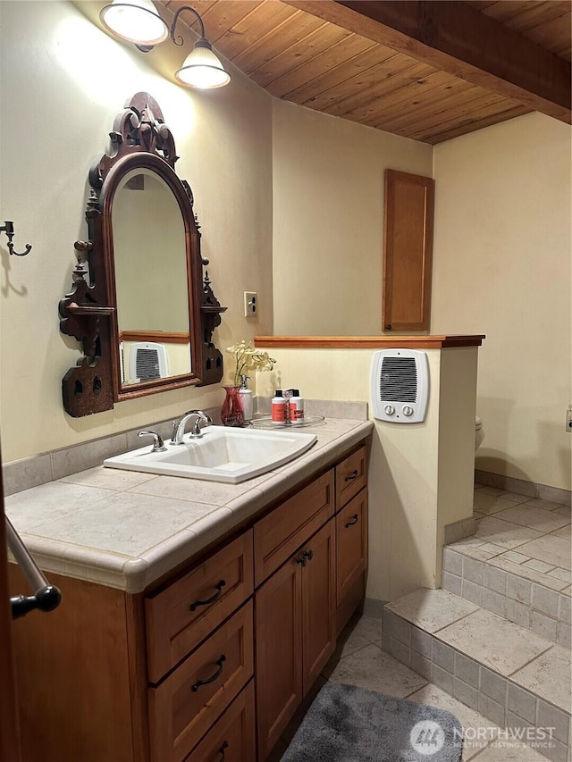 5790 NE Old Mill Rd NE, Bainbridge Island, WA 98110 - bathroom with wooden ceiling, beamed ceiling, vanity, toilet, and tile patterned floors