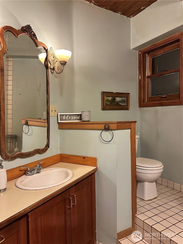 5790 NE Old Mill Rd NE, Bainbridge Island, WA 98110 - bathroom featuring toilet, tile patterned floors, and vanity