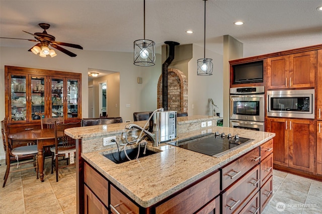 231 Valley Way, Woodland, WA 98674 - kitchen featuring stainless steel appliances, a center island with sink, hanging light fixtures, recessed lighting, and light stone counters