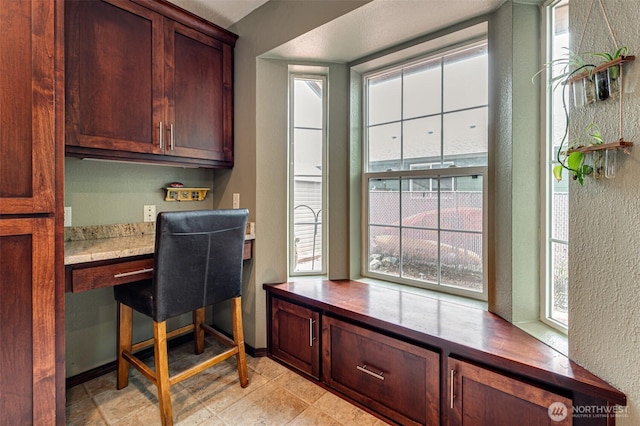 231 Valley Way, Woodland, WA 98674 - office space with built in study area, a textured wall, and baseboards
