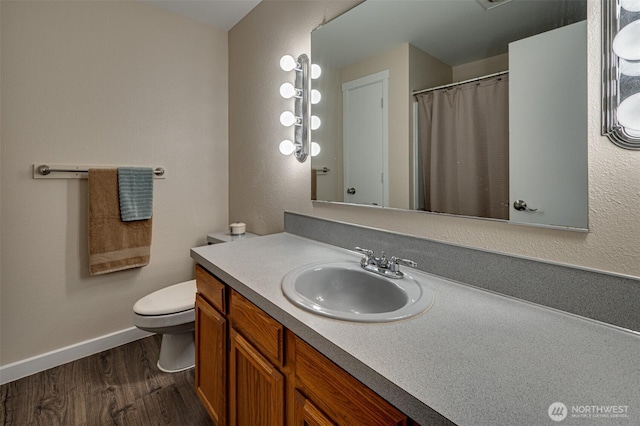 231 Valley Way, Woodland, WA 98674 - bathroom featuring wood finished floors, baseboards, toilet, vanity, and a shower with curtain