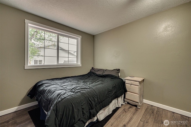 231 Valley Way, Woodland, WA 98674 - bedroom with baseboards, wood finished floors, and a textured ceiling