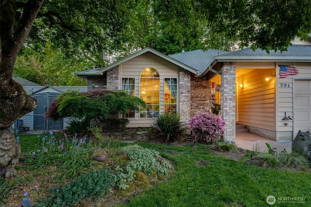 231 Valley Way, Woodland, WA 98674 - view of front of home with a garage, brick siding, and a shingled roof