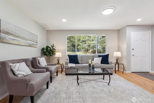 living room featuring wood finished floors, baseboards, and recessed lighting