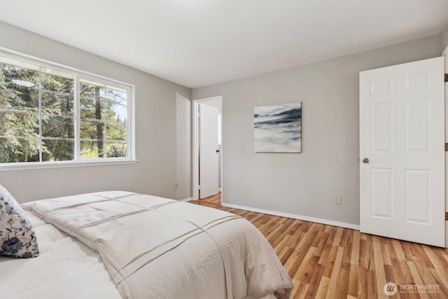 bedroom featuring light wood-type flooring and baseboards