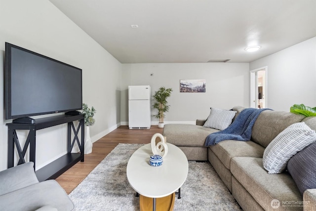 living room with wood finished floors and baseboards