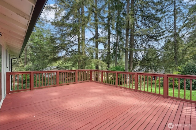 wooden terrace featuring view of scattered trees