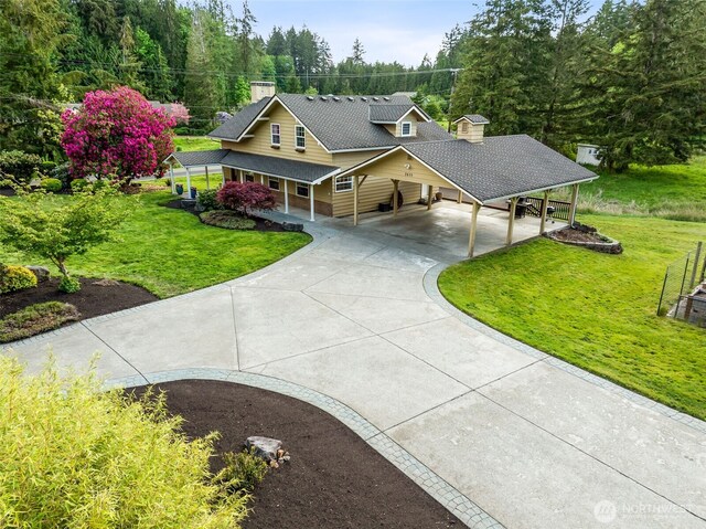 farmhouse-style home with concrete driveway, a carport, a front lawn, and a chimney