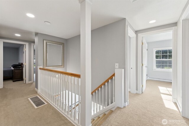 hall featuring carpet, an upstairs landing, recessed lighting, baseboards, and baseboard heating