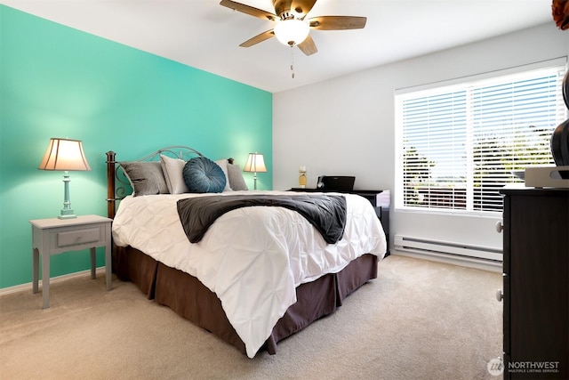 bedroom featuring a baseboard heating unit, carpet, and a ceiling fan