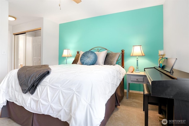 bedroom with light colored carpet and a closet
