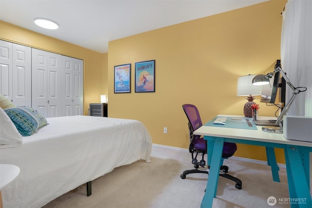 bedroom with a closet, carpet, baseboards, and a desk