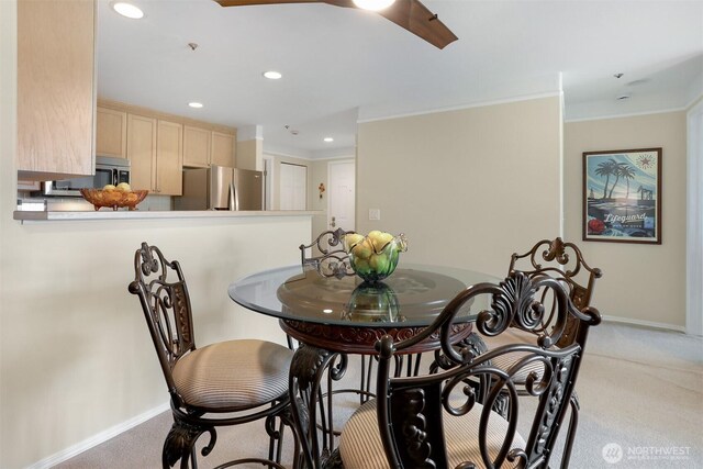 dining room with carpet floors, crown molding, baseboards, and recessed lighting