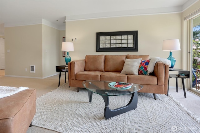 living area with carpet, baseboards, and crown molding