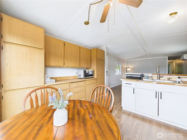 212 Old Owen Rd Unit 43, Sultan, WA 98294 - dining area with light wood-style flooring, a ceiling fan, a wall unit AC, and baseboards