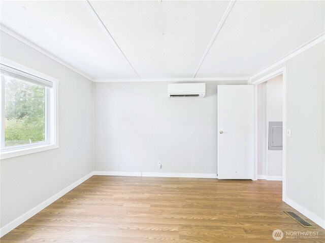 212 Old Owen Rd Unit 43, Sultan, WA 98294 - empty room featuring a wall unit AC, light wood finished floors, and baseboards