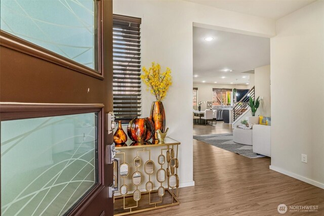 entrance foyer featuring wood finished floors, recessed lighting, baseboards, and stairs