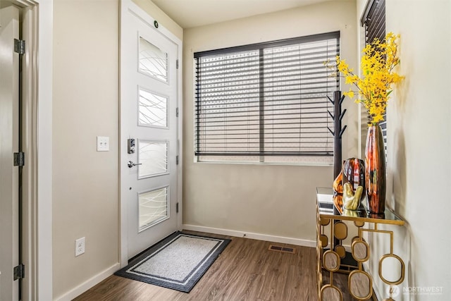 entrance foyer with wood finished floors and baseboards