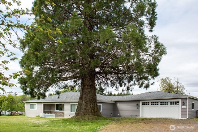 343 Hawkins Rd, Winlock, WA 98596 - view of front of property featuring a garage, a front lawn, driveway, and roof with shingles
