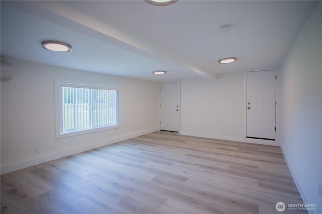343 Hawkins Rd, Winlock, WA 98596 - empty room with light wood-style floors, baseboards, a wall mounted AC, a smoke detector, and beamed ceiling