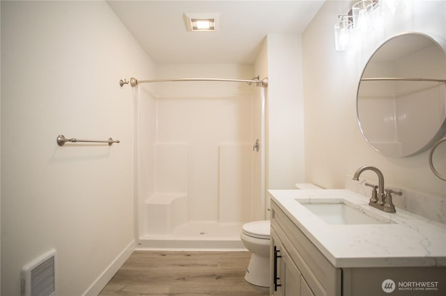 343 Hawkins Rd, Winlock, WA 98596 - full bath with wood finished floors, toilet, a shower, vanity, and baseboards