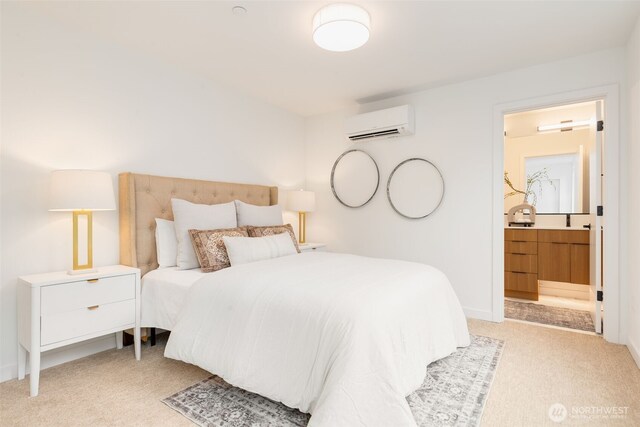 bedroom with an AC wall unit, carpet floors, ensuite bathroom, and baseboards