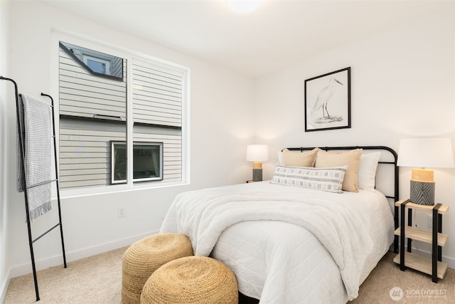 bedroom with carpet floors and baseboards