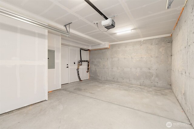 garage featuring a garage door opener and electric panel