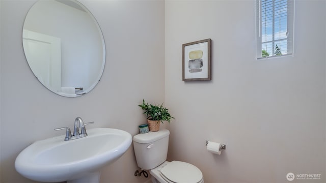 half bathroom with a sink and toilet